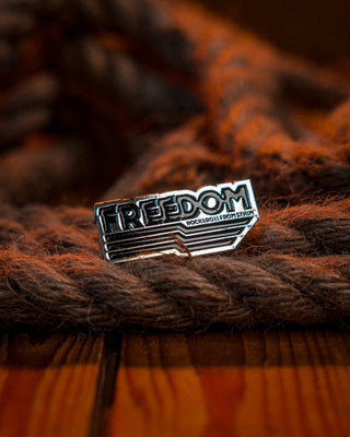 Enamel pin for the swedish rockband Freedom by mangobeard